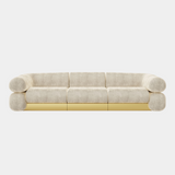 The Fitzgerald Sofa by Studiopepe. This oversized sofa with a low backrest and brass accents brings sophistication to any living space.