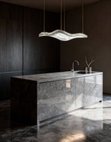 United Alabaster Aire Pendant Light above a kitchen island