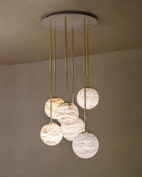 United Alabaster Moon Cluster Pendant Light in six natural alabaster spheres on satin gold brass stems with a matt white canopy