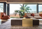 Alessio armchairs in rust leather in a living room with garden views
