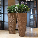 Bertarelli Curved Wave Luxury Floor Vase in bronze, pair in an interior setting