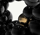 Boca do Lobo Newton Black Gold Dining Table, close-up of the black lacquered and gold spheres