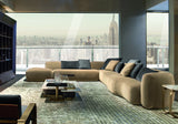 Catone modular corner sofa in sand velvet in a penthouse living room with city views