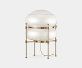 Chevalier: Sculptural Table Lamp in Gold-Plated Brass & Glass. The Chevalier table lamp by Mezzo Collection stuns with its sculptural brass frame and elegant glass shade, casting a captivating glow in any modern living space.