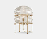 Illuminate Your Living Room with the Chevalier Table Lamp. Bathe your space in warm, inviting light with the Chevalier table lamp. This sculptural gold-plated brass and glass masterpiece by Mezzo Collection is a statement piece for any modern living room.