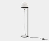 Laskasas Clarke Floor Lamp with Carrara marble base and spherical glass shade in a modern living room.