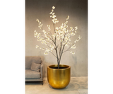Dorata Gold Leaf Luxury Floor Planter in gold leaf, planted in a living room