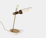 Illuminate Your Living Room with the Emerson Sculptural Table Lamp. Add a touch of modern elegance to your living room with the Emerson table lamp by Mezzo Collection. This captivating design features a bold, asymmetric form in gold-plated brass, a sleek glass shade, and a luxurious Carrara marble base, bathing your space in warm, inviting light.