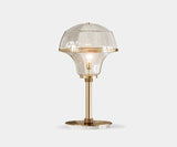 Harlow: Mid-Century Modern Table Lamp in Glass, Marble & Gold. The Harlow table lamp by Mezzo Collection captures the essence of mid-century modern design with a luxurious twist. This exquisite piece features a sleek glass enclosure, a Carrara marble base, and gleaming gold-plated brass accents, perfect for a touch of retro chic in any modern living space.