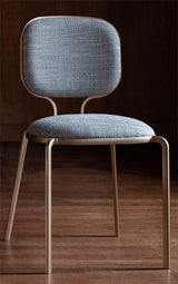 Jacopo Cast Frame Luxury Dining Chair in grey, in a room setting