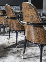 A Fusion of Luxury and Functionality: The Jera Padded Chair by Visionnaire. This modern chair features a comfortable curved frame, luxurious quilted velvet upholstery, and a sleek lacquered metal handle for easy maneuverability.