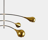 Mid-Century Modern Ceiling Lamp Design: Black Metal & Gold Accents. The Arlo ceiling lamp by Mezzo Collection embodies the essence of mid-century modern design. This image highlights the lamp's key design elements: a sleek black metal pole, contrasting beautifully with the warmth of the gold-plated brass accents and the light-diffusing glass enclosures.