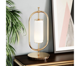 Minimalist Table Lamp Design: Gold-Plated Brass & Marble. The Beaumont table lamp by Mezzo Collection showcases the enduring power of minimalist design. This image highlights the lamp's key features: a sleek oval frame in gleaming gold-plated brass and a luxurious Carrara marble base.