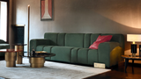 Ruolo nesting coffee tables in front of a green velvet sofa