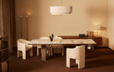 Siena curved dining chairs in cream boucle around a marble dining table