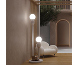Skylab Floor Lamp: A Curved Silhouette Inspired by Mid-Century Modern Design. Make a statement in your home with the Skylab floor lamp by Mezzo Collection. This minimalist masterpiece features a single, captivatingly curved white metal frame and a gleaming gold brass base, capturing the essence of mid-century modern design.
