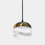United Alabaster Copper Pendant Light in natural alabaster with a satin gold brass cap, studio view on grey