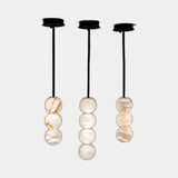 United Alabaster Raïm Pendant Light in natural alabaster, studio view on grey