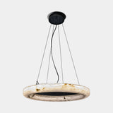 United Alabaster Ring Pendant Light in natural alabaster with a matt black canopy, studio view on grey