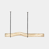 United Alabaster Signature Pendant Light in natural alabaster with a matt black structure, studio view on grey