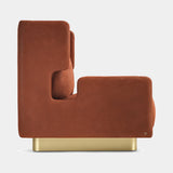 Alessio armchair in rust leather on a satin brass plinth, side view