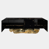 Modern black sideboard with a sculptural brass base and a sleek black marble top. The Angra Sideboard by Boca do Lobo offers ample storage and a touch of sophisticated style for your living room.