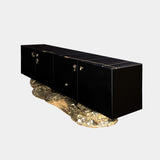 Black high-gloss sideboard with a unique hammered brass base, inspired by the cliffs of Angra do Heroismo. The Angra Sideboard by Boca do Lobo is a true conversation starter.