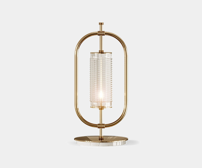 Beaumont: Minimalist Table Lamp in Gold-Plated Brass & Marble.  The Beaumont table lamp by Mezzo Collection embodies minimalist luxury.  This exquisite piece features a sleek oval frame in gold-plated brass and a Carrara marble base, casting a warm glow in any modern living space.