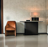 Amphora curved console table with channel quilted leather base and marble top styled in an entrance hall
