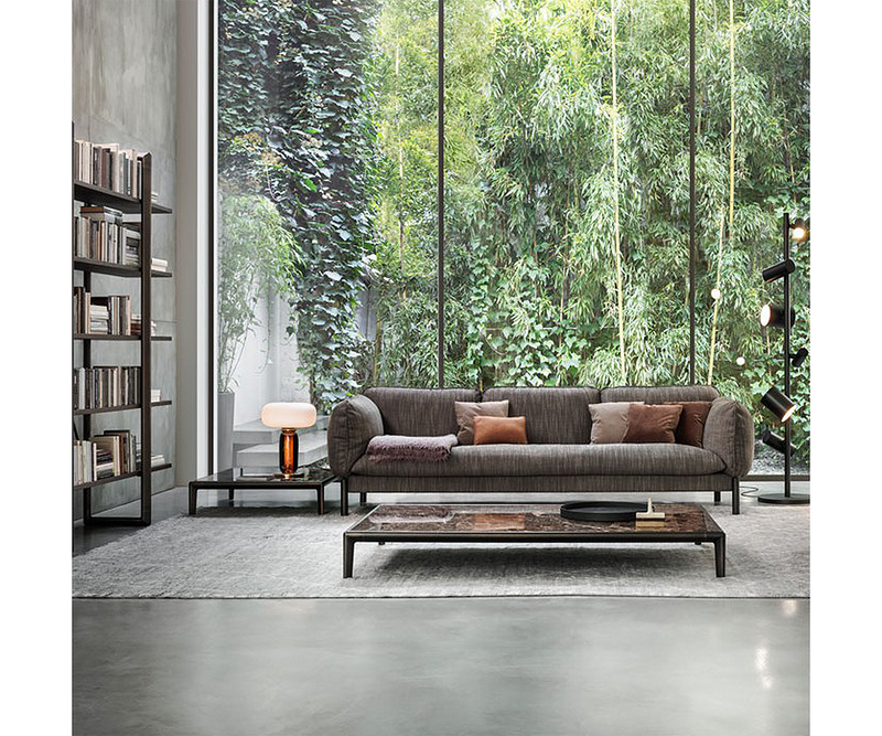 Luxury blown glass and polished metal Ghidini1961 lamp creating a warm atmosphere in modern living spaces.
