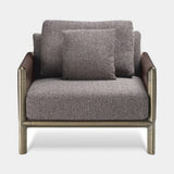 Doria Leather Clad Luxury Armchair in patterned fabric with brown burnished brass
