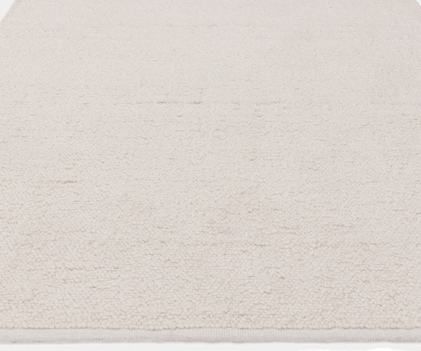 Handcrafted Abbus rug adding elegance to a modern living room with plush underfoot comfort.