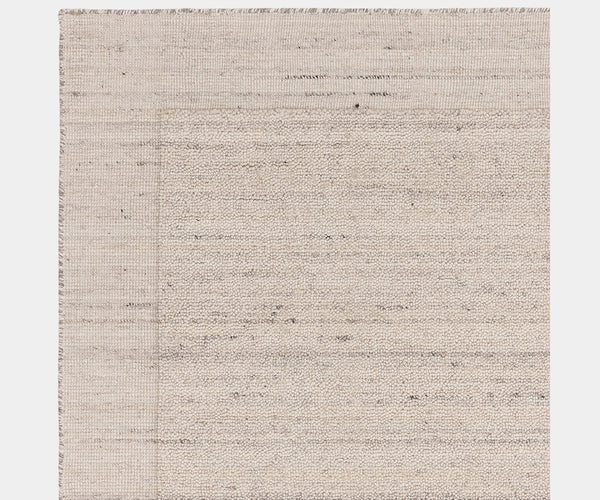 Handcrafted Larson Ivory rug enhancing a contemporary, high-end living room.