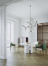 Round Marble Oriol Dining Table with Metal Detailing styled in a luxury interior