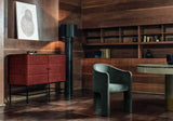 Siena curved dining chair in sage velvet beside a red lacquered cabinet