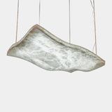 United Alabaster Aire Pendant Light in natural alabaster with a satin gold brass structure, studio view on grey