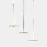 United Alabaster Nuvol Pendant Light in natural alabaster with a matt black structure, studio view on grey