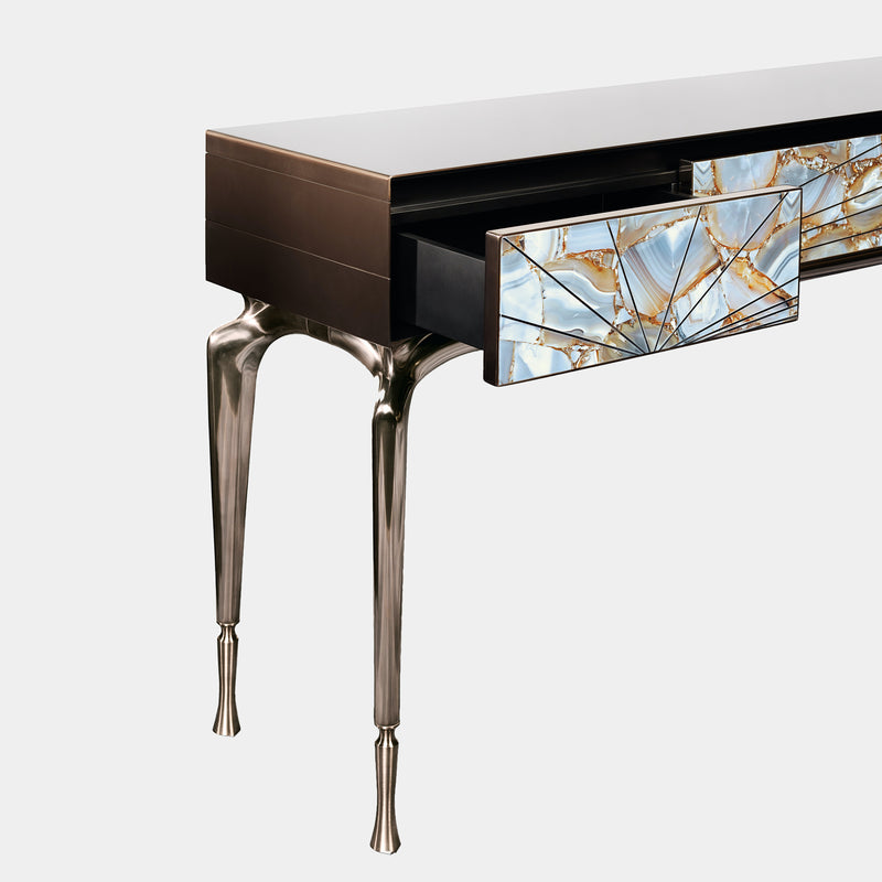The Art of Storage: The Aurora Console by Steve Leung. This luxurious console boasts three drawers clad in brushed stainless steel, adorned with a stunning marble inlay framed and accented with polished steel. The customizable metal base adds a touch of personalised elegance.