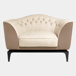 Visionnaire Freyr Armchair: Modern luxury armchair with a curved shell, plush upholstery (leather or fabric options), and slender wooden feet with metal tips.
