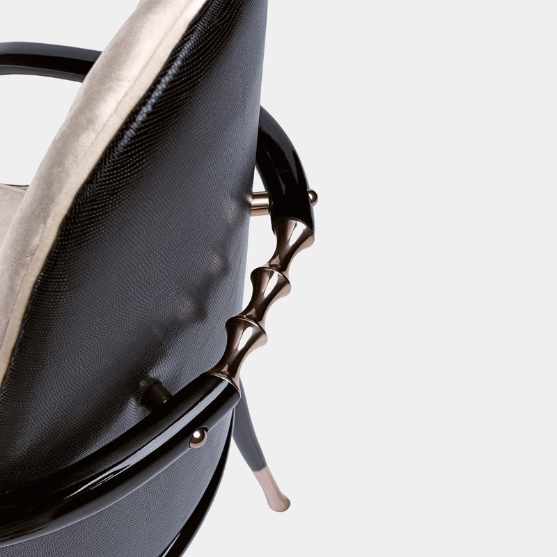 The Art of Modern Comfort: The Jera Padded Chair. Visionnaire's masterpiece combines a captivating organic shape with luxurious quilted velvet upholstery, a supportive interior padding, and a sleek lacquered metal handle, creating a statement piece for any living space.